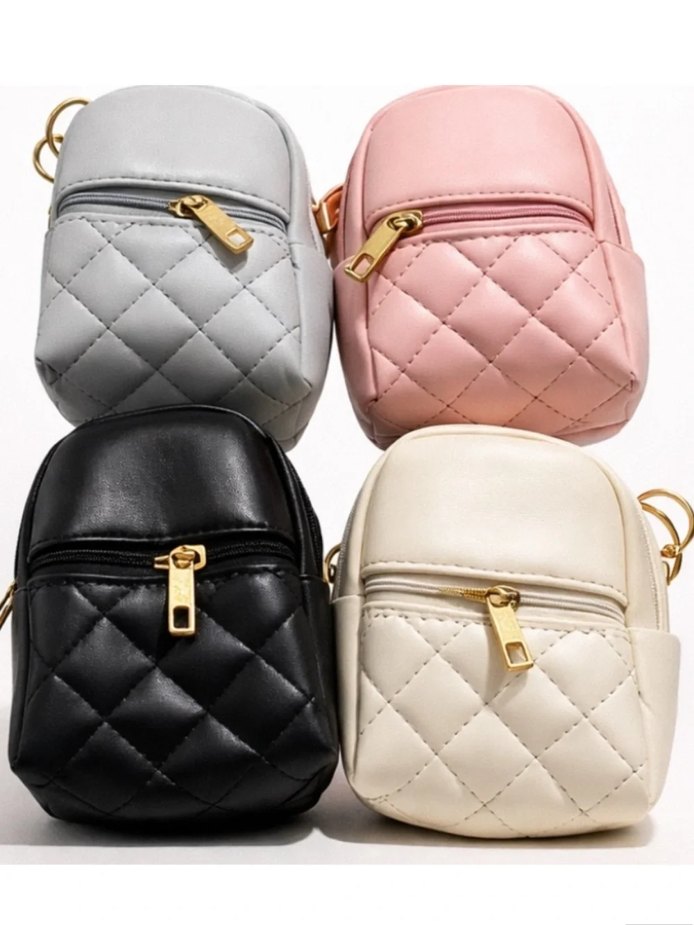 Mini backpack keychain charms, blue, pink, black, cream colors.